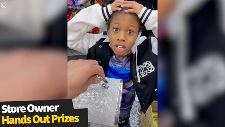 Store owner gives children prizes for answering quiz questions correctly