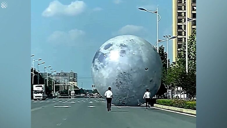 Workers chase after GIANT moon balloon blown away by strong winds