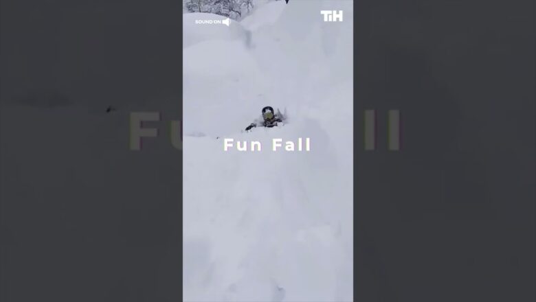 Person Falls Into Snow After Skiing off Incline