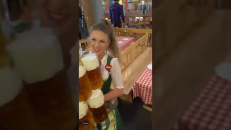 Oktoberfest waitress carrying massive stack of beers wows onlookers | USA TODAY #Shorts
