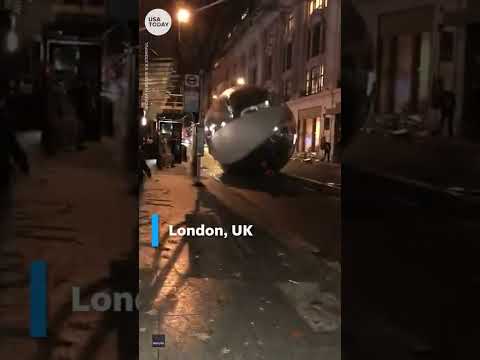 Giant Christmas ornaments tumble through windy London streets | USA TODAY #Shorts