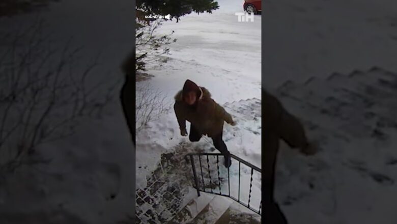 Woman Keeps Slipping While Climbing Up Snow Covered Stairs