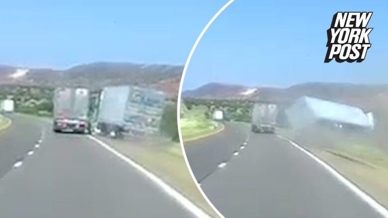 Overturned big rig pushed off road by another truck