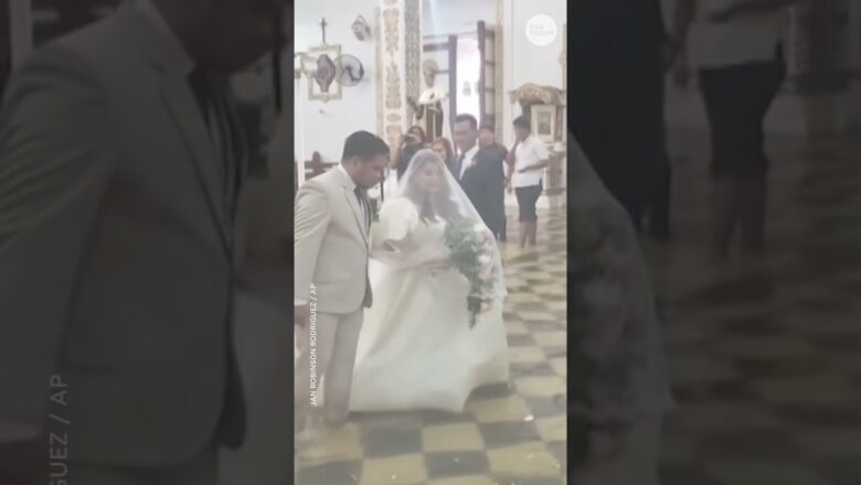 Bride makes waves as she walks down aisle of flooded church #Shorts