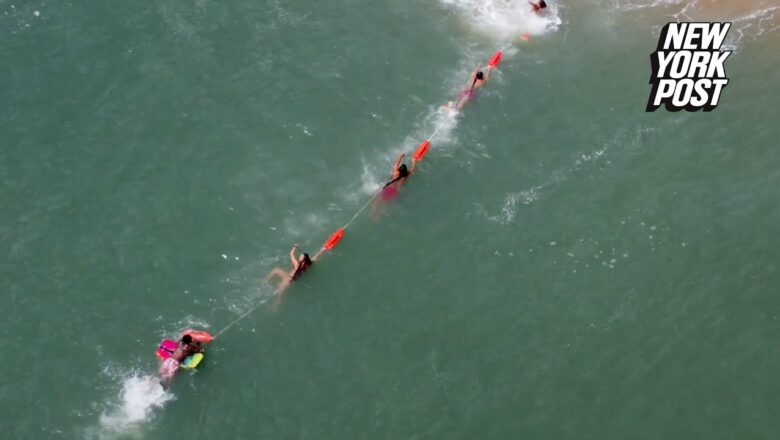 Florida lifeguards form human chain to rescue boogie boarder from deadly rip current: video