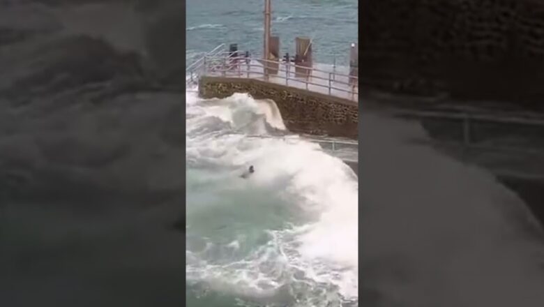 Kid saved by bystander after being swept from pier by high tides #Shorts