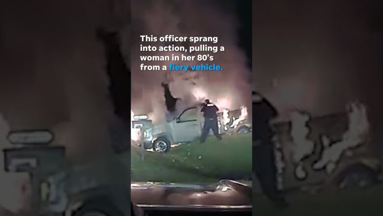 Watch this heroic officer save a woman from a burning vehicle #Shorts