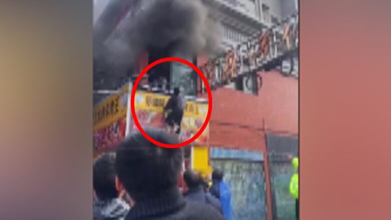 People jump from windows to escape building fire in China