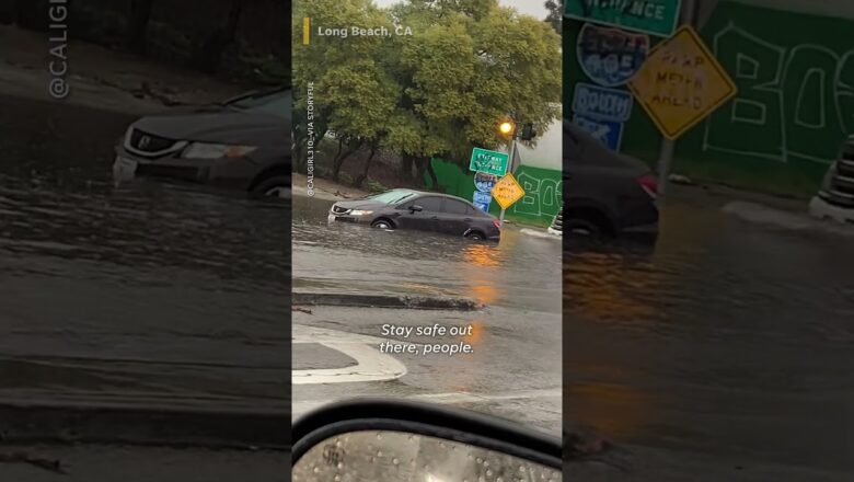 Watch: Cars drive through flooded roads, dam opens in California #Shorts