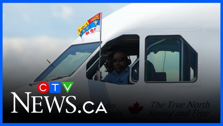 Pilot holds up standard after King Charles and Queen Camilla land in Ottawa