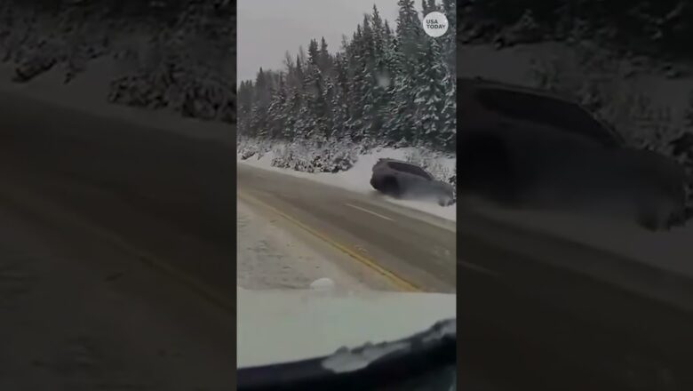 Officer narrowly dodges a car skidding off the road amid a snowstorm