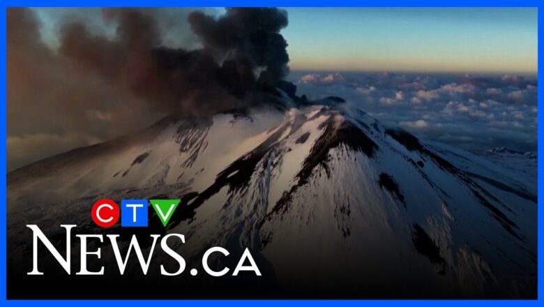 Skier glides down Mount Etna during an eruption