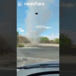 Huge Dust Devil Forms Outside Mans House
